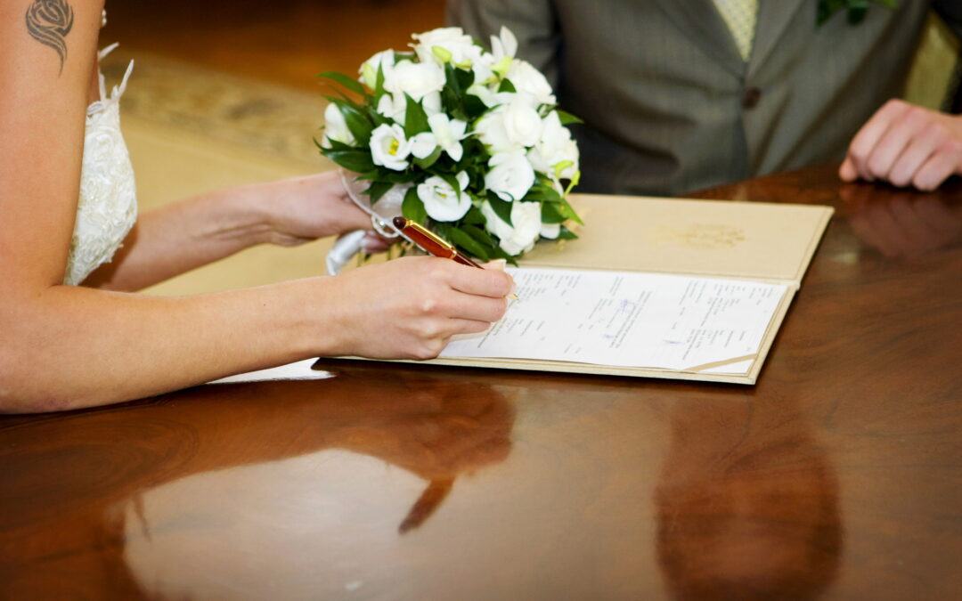 Wedding couple signing paperwork