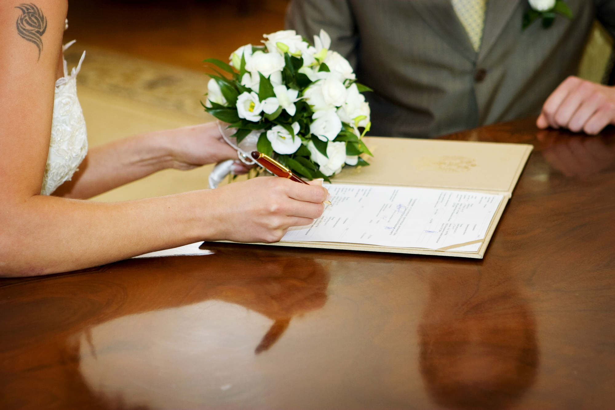 Wedding couple signing paperwork