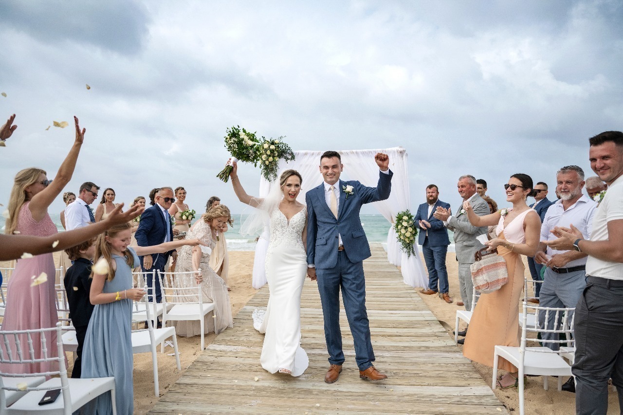 wedding couple walking down the aisle holding hands