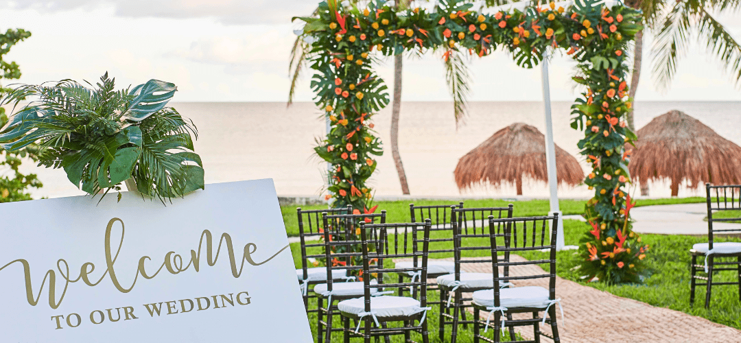 Gardens at Hyatt Ziva Riviera Cancun featuring a small wedding ceremony set up in green grass with the beach in the background