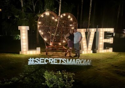 Ashley and Jake in front of Love sign