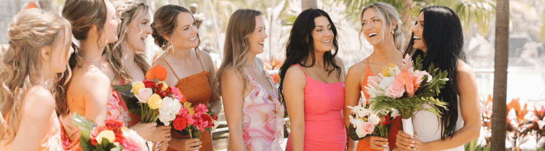 Bridesmaids standing in a line with the bride at a destination wedding.