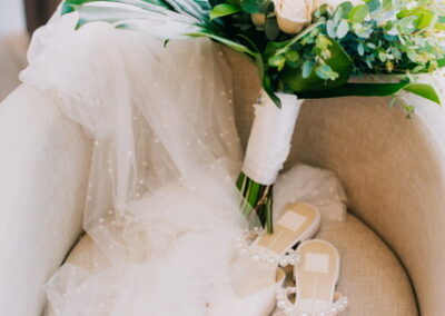 Bridal veil, shoes and bouquet on a chair