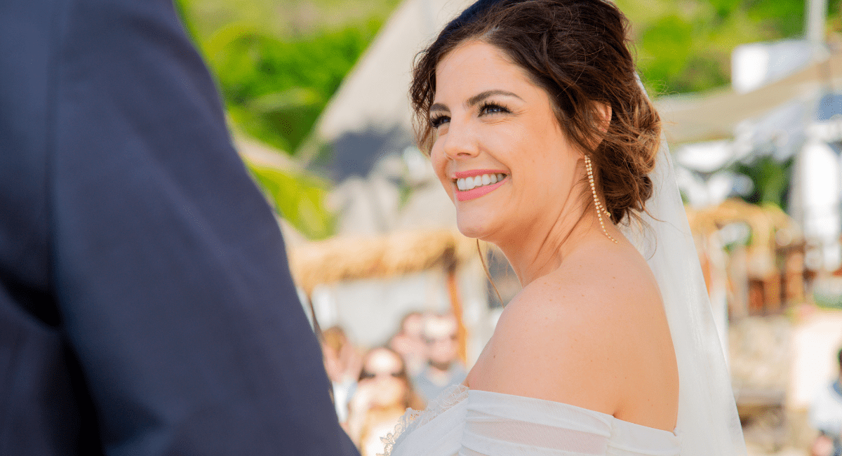 Bride looking at her groom during a beach destination wedding ceremony