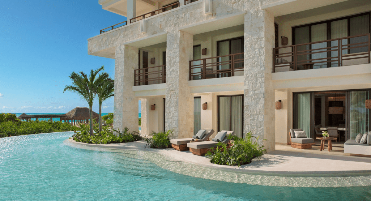 Destination-wedding-room-block All-inclusive resort guest building with swim-up rooms for a destination wedding room block.
