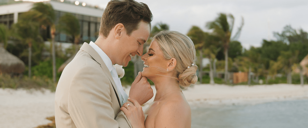 Close up picture of destination wedding couple smiling happy at each other